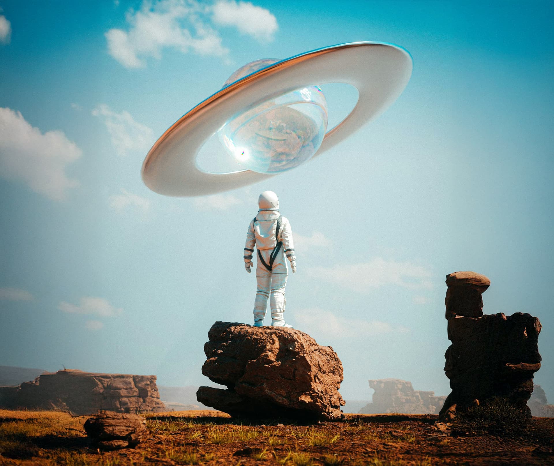 Astronaut standing on a rocky alien landscape looking at a futuristic floating spacecraft shaped like a glass sphere with a large ring around it under a blue sky.